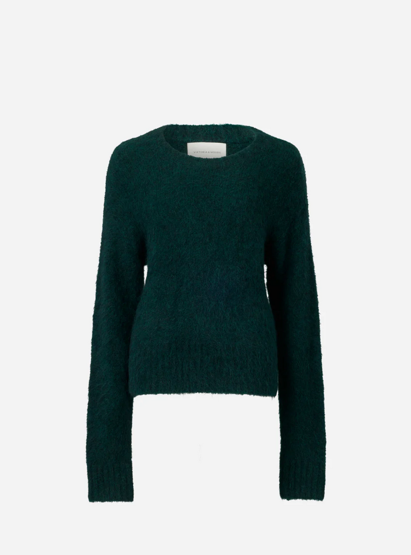 Deep green crew neck style knit with ribbed cuffs.